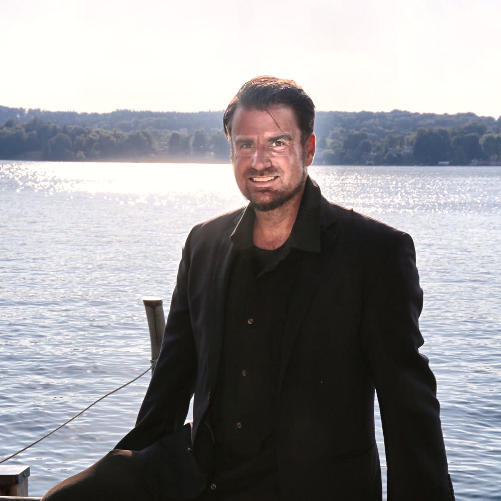 Andreas Ehstand, AI Scientist at Augmanitai, portrait by a lake